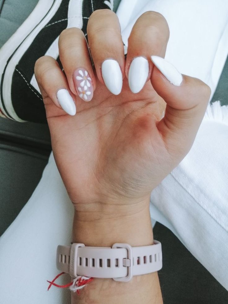 Chic Almond-Shaped White Nails with Delicate Floral Accent for a Minimalist Yet Whimsical Look.