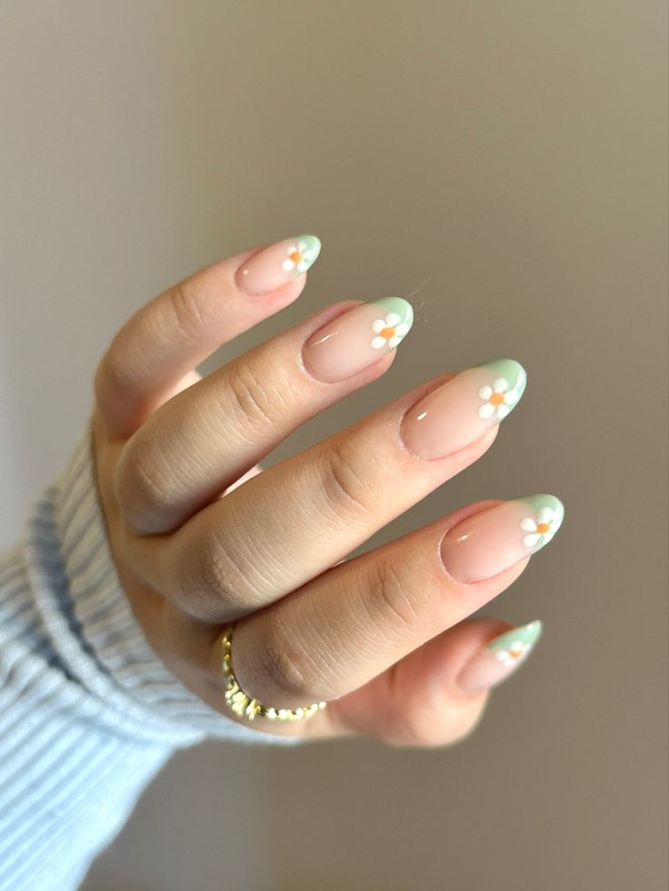 Charming Floral Nail Design with Mint Green Tips and Whimsical White Accents.