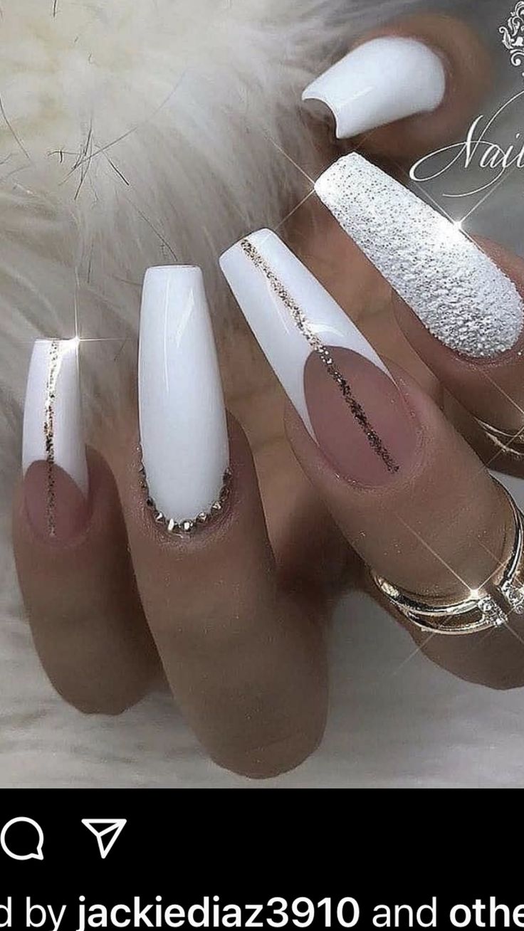 Sophisticated Nail Art: Glossy White and Nude with Gold Accents and Glitter Finish.