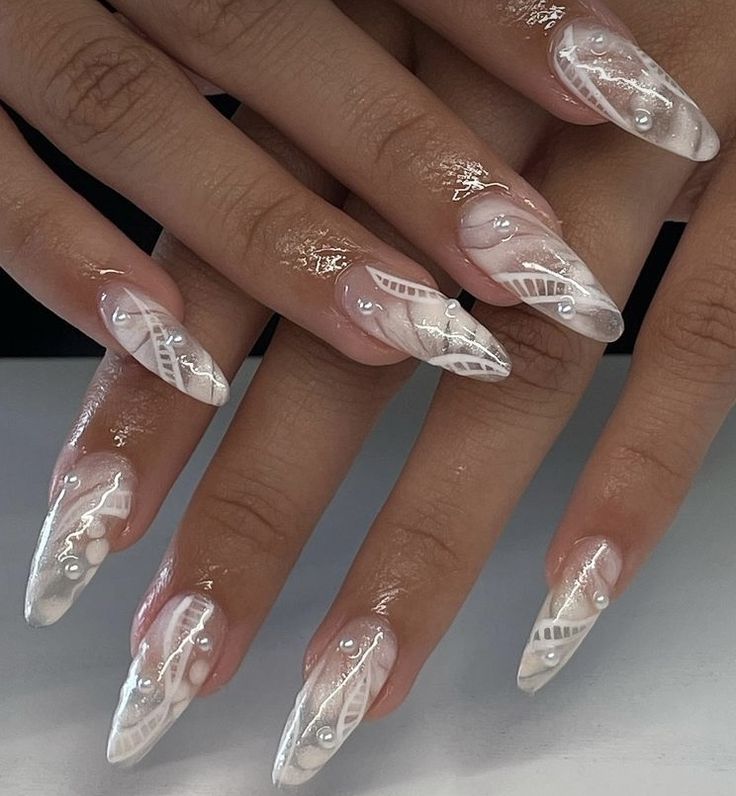 Elegant Stiletto Nail Design with Intricate Patterns and Glitter Accents for Special Occasions