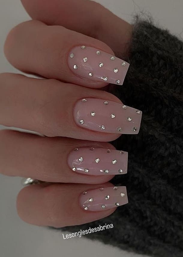 Chic Sheer Pink Nail Design with Shimmering Rhinestones for Glamorous Occasions.