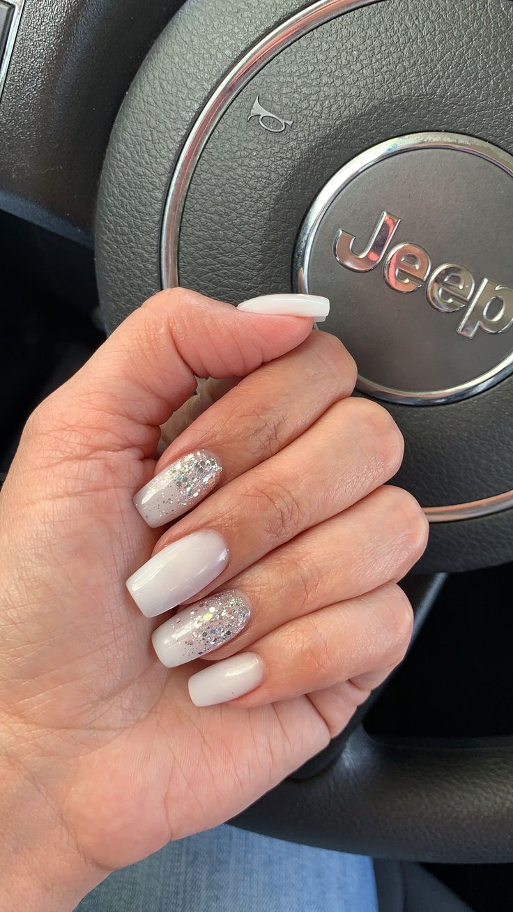 Sophisticated French Tip Nail Design with Gradient and Glitter Accents.