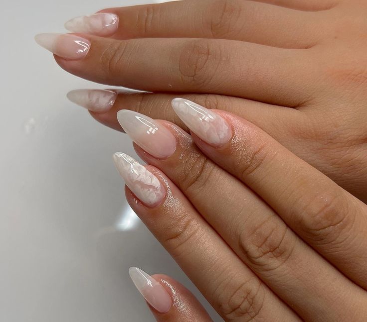 Elegant Almond-Shaped Nails with Subtle Ombre and Artistic Marble Designs.