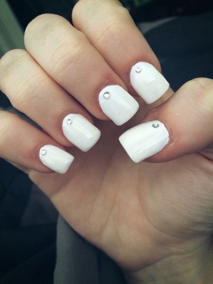 Chic White Geometric Nail Art with Sophisticated Gem Accents.