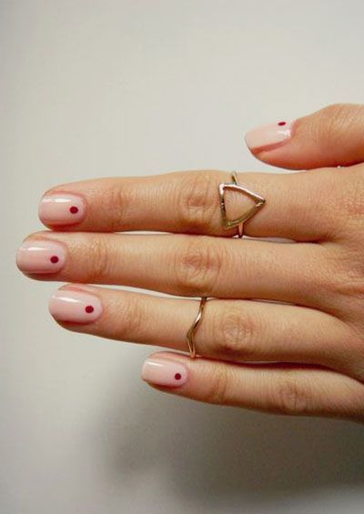 Elegant Nude Nail Design Enhanced by Minimalistic Red Dots and Gold Rings.