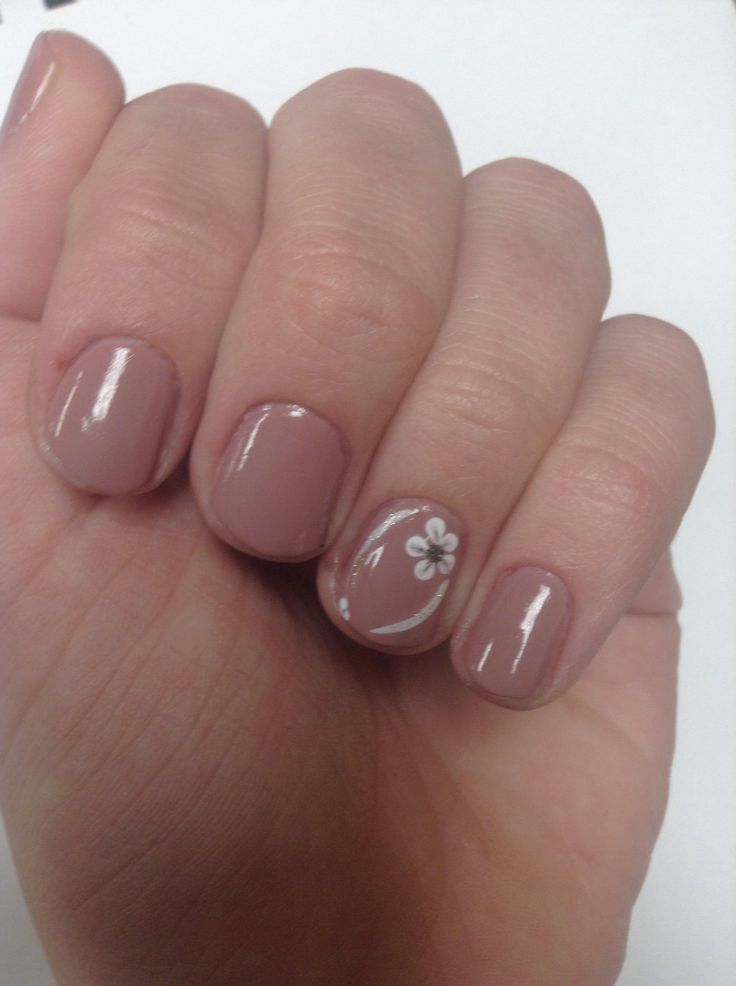 Charming Floral Accent on Soft Nude Nail Design.