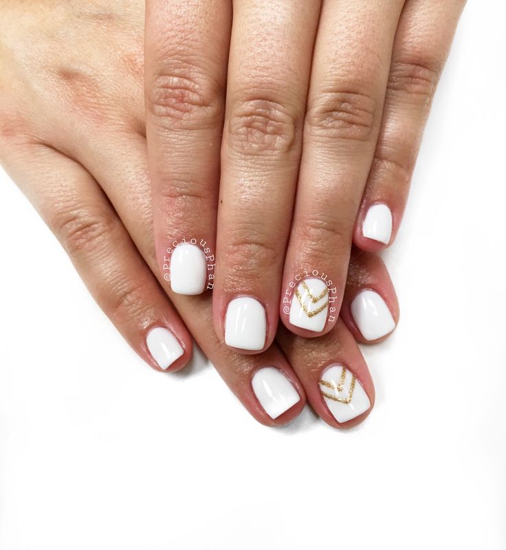 Sophisticated Minimalist Nail Design with White Base and Gold Geometric Accents.