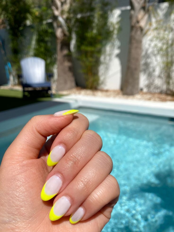 Playful Neon Yellow French Tip Manicure: A Modern Twist on a Classic Design.