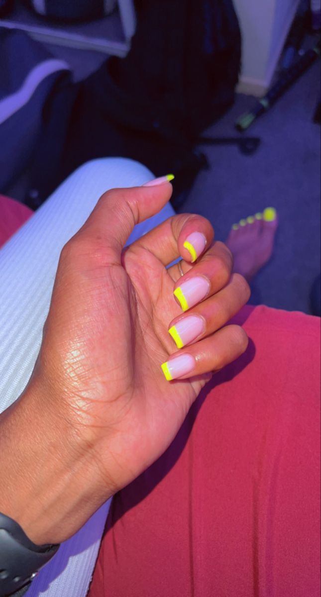 Modern French Tip Nail Design with Neon Yellow Twist on Soft Pink Base.