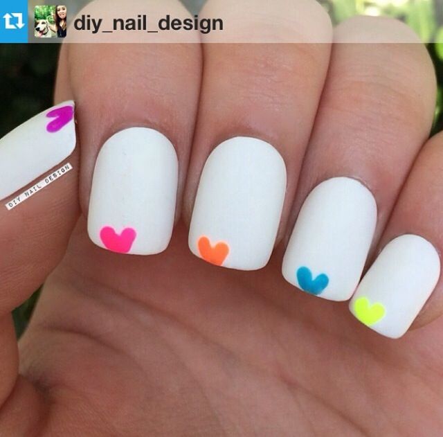 Whimsical Nail Design: Playful Heart Accents on a Clean White Base.