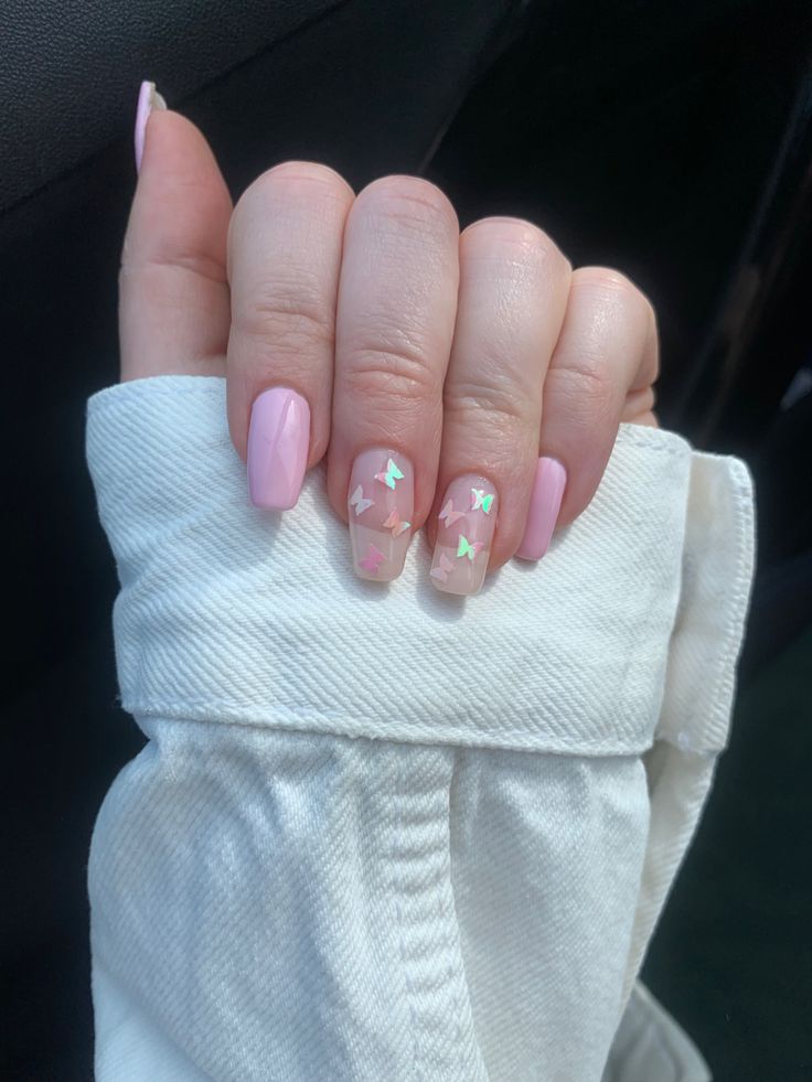 Elegant Soft Pink Nail Design with Playful Star Glitter Accent.