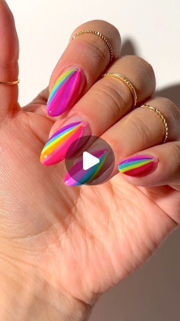 Vibrant and Playful Nail Design with Diagonal Stripes in Pink, Yellow, and Green.