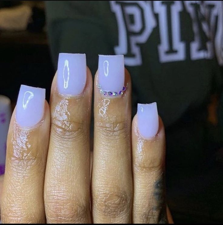 Glossy Pastel Purple Nails with Delicate Rhinestone Accents for Modern Elegance.