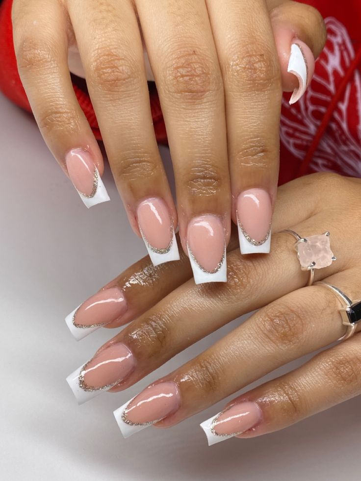 Sophisticated French Manicure with Soft Pink, White Tips, and Silver Accents.