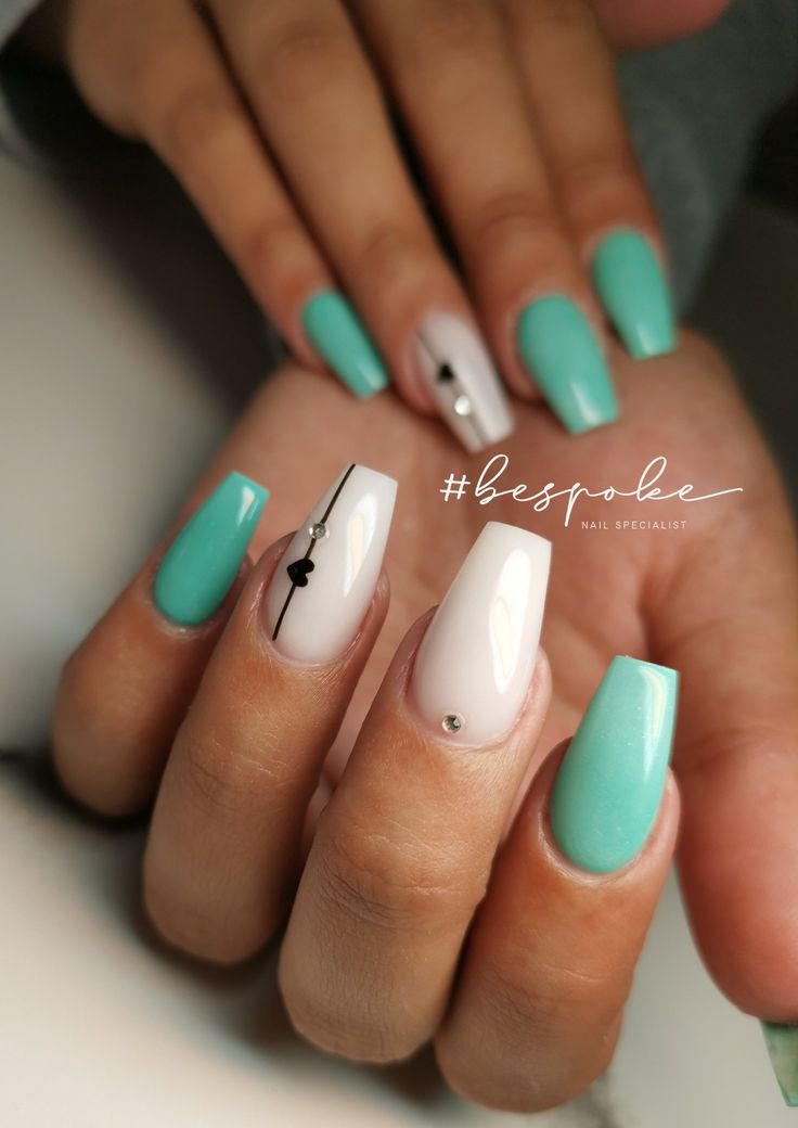 Sophisticated Pastel Nail Design: Mint Green Meets Elegant White Accents.