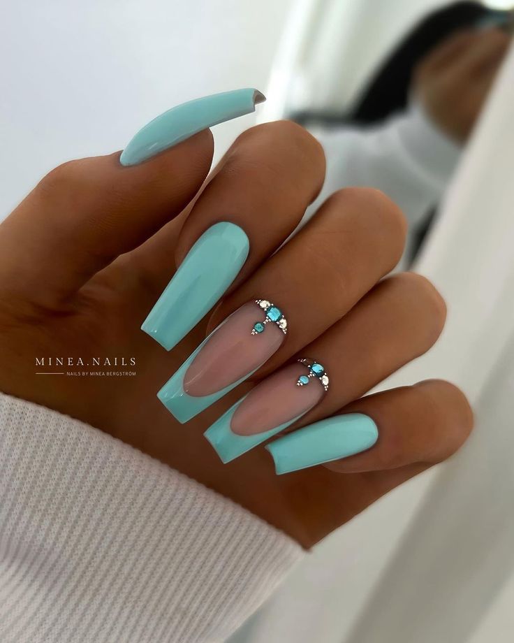 Chic Pastel Blue Manicure with Rhinestones and Elegant Finish.