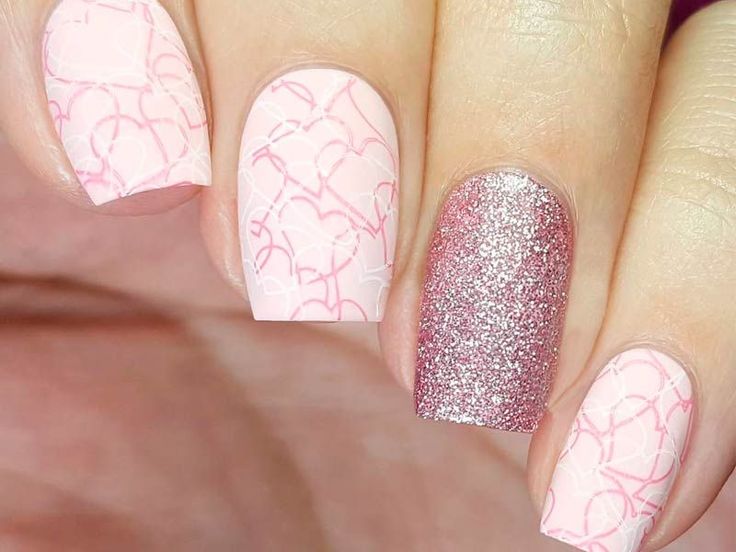 Charming Pink Nail Design with Pastel Shades and Glitter Accents.