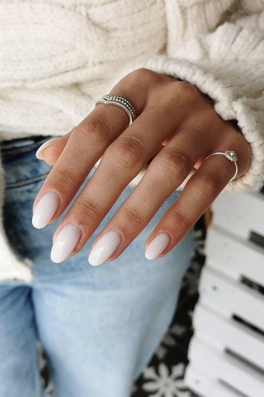 Chic Elegant Almond-Shaped Nails with Soft White Polish and Minimalist Silver Accents