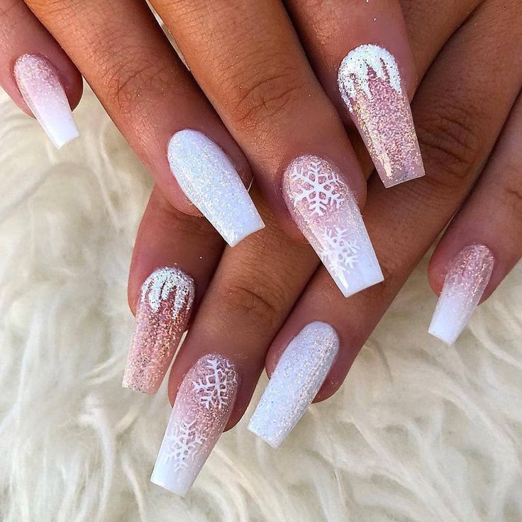 Elegant Winter-Themed Nail Design with Snowflake Patterns and Sparkly Gradient Hues.