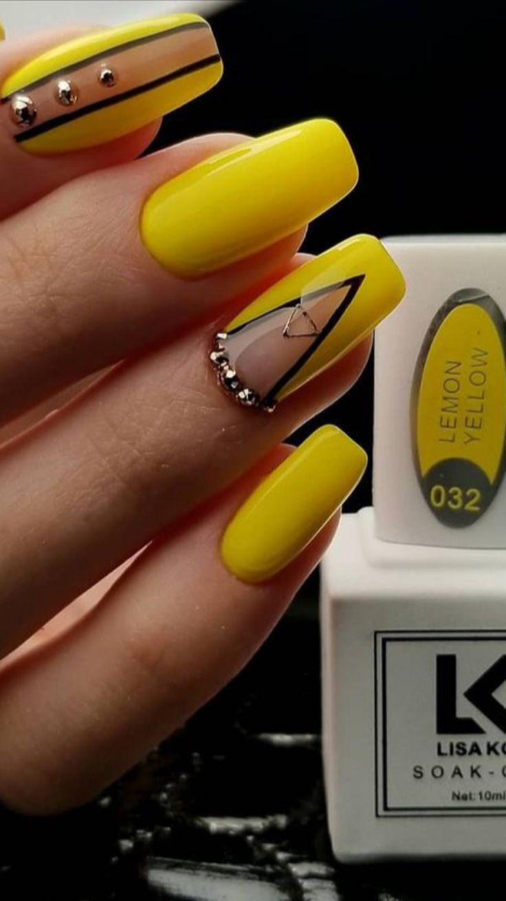 Bold Yellow Nails with Geometric Designs and Sophisticated Accents.