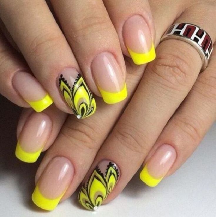 Bold Floral-Inspired Nail Design with Bright Yellow Tips and Elegant Black Detailing.