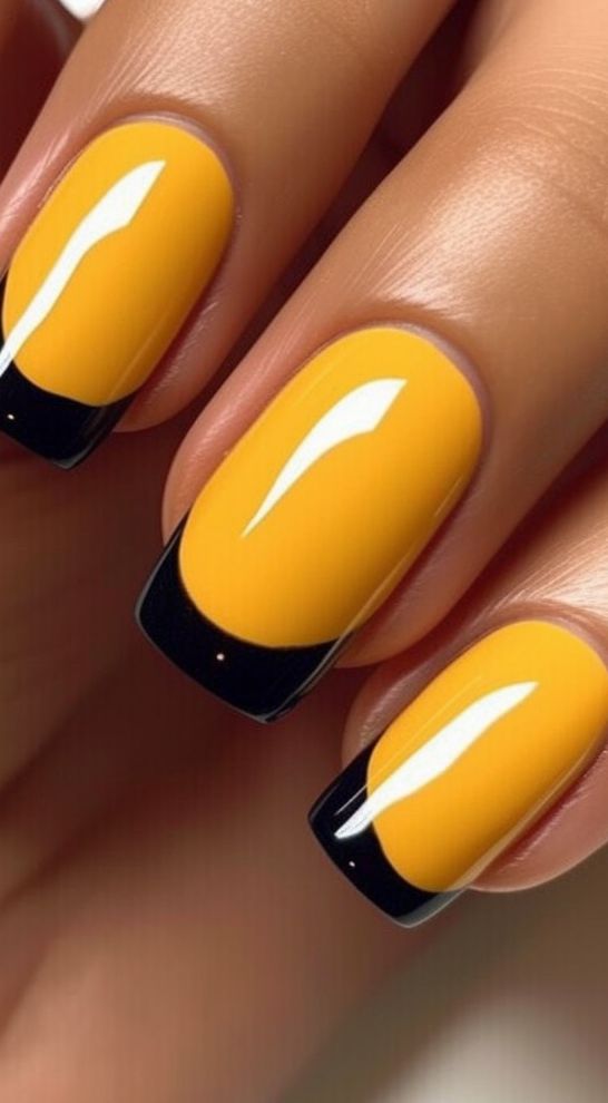 Chic Nail Design: Vibrant Yellow with Sleek Black Tips for a Bold Statement.