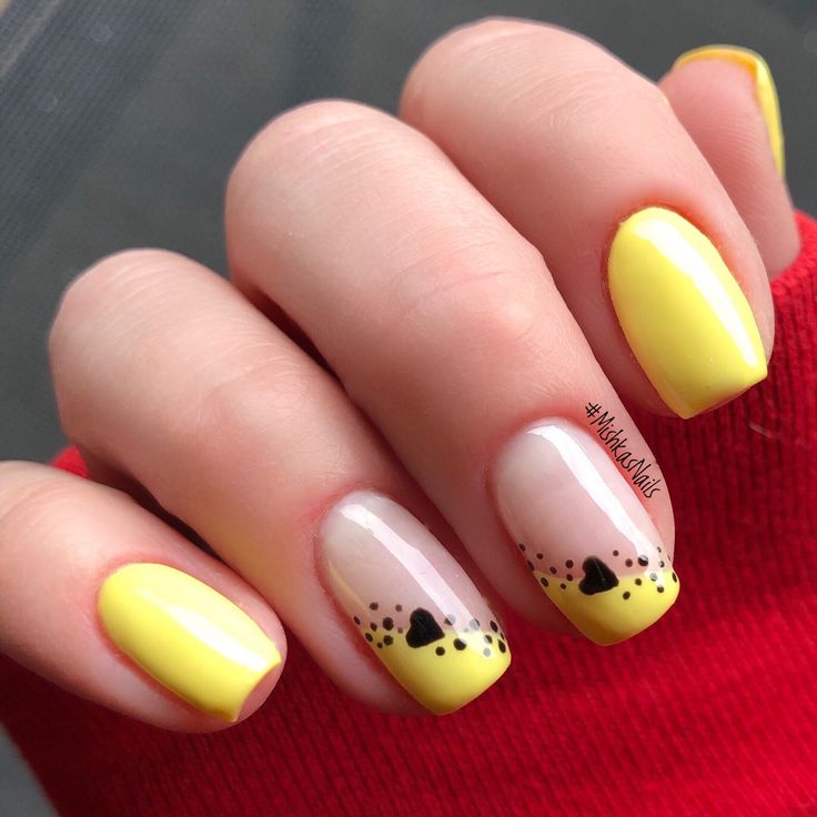 Cheerful Yellow Nail Art with Playful Designs and Charming Accents.