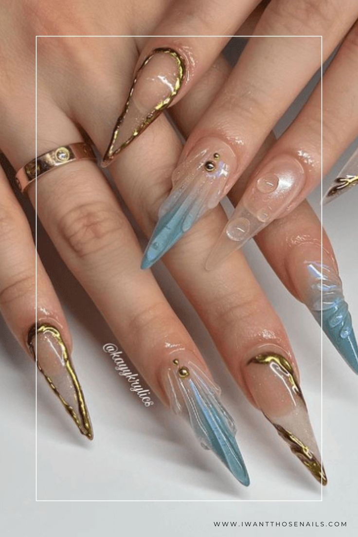 Chic Stiletto Nails with Translucent Designs and Gold Accents