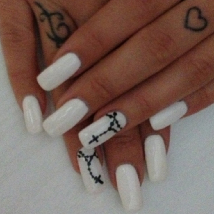 Elegant White Nails with Glossy Finish and Intricate Black Cross Designs for a Minimalist yet Spiritual Look.