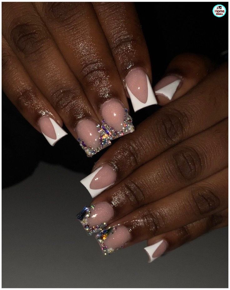 Chic Nude and White Tip Nail Design Adorned with Glitter and Rhinestones for a Glamorous Touch.