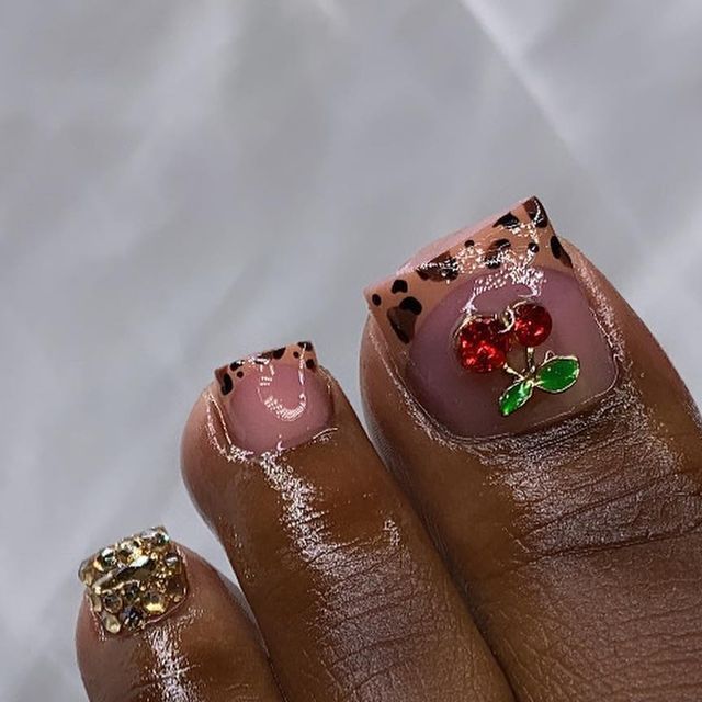 Trendy Nail Art: A Stylish Fusion of Animal Prints and Fruit Motifs with Sparkling Accents.