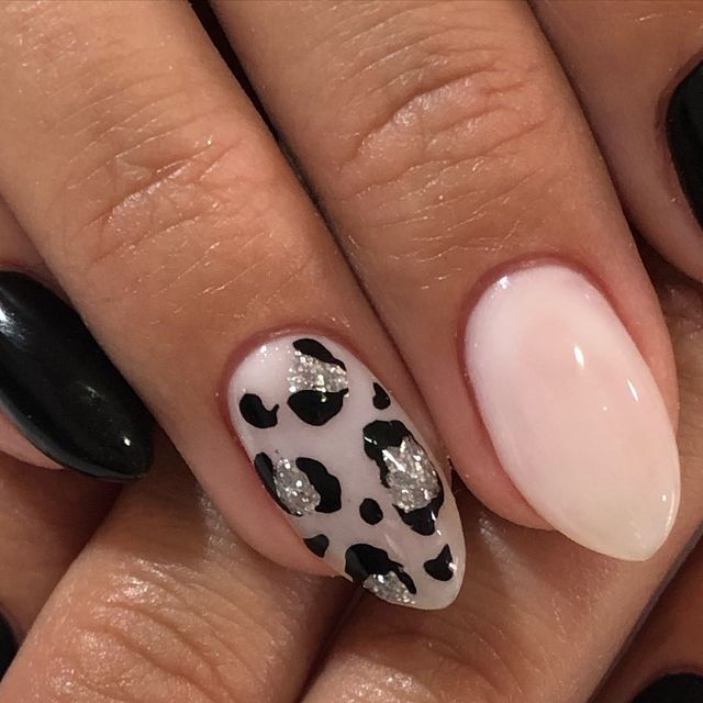 Chic Leopard Print Nail Design with Glossy Black, Soft Nude, and Sparkly Silver Accents.