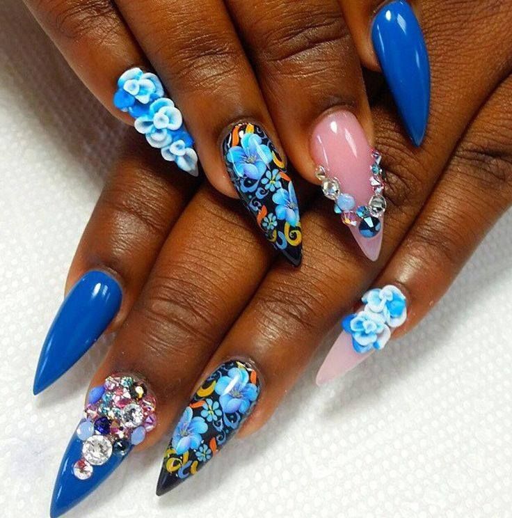 Vibrant Nail Design Merging Deep Blue and Pastel Pink with Floral Art and Sparkling Embellishments.