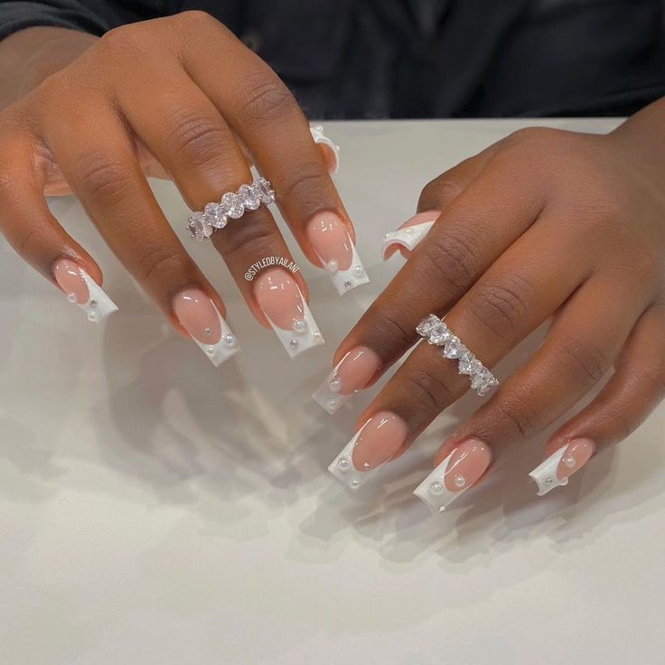 Sophisticated French Tips with Elegant Nude Base and Pearl Embellishments