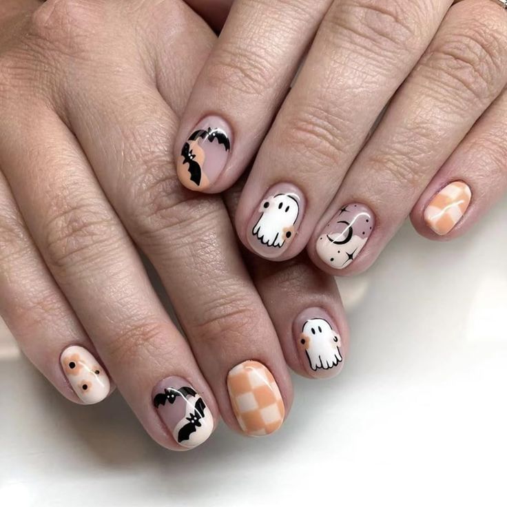 Whimsical Halloween Nail Design with Cute Ghosts, Bats, and Soft Pastel Colors.