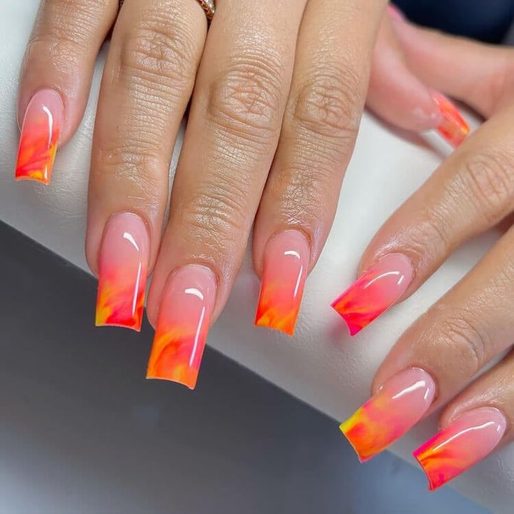 Stunning Ombre Nail Design: Vibrant Gradient from Nude to Fiery Orange-Pink with Glossy Finish for a Bold Summer Look.