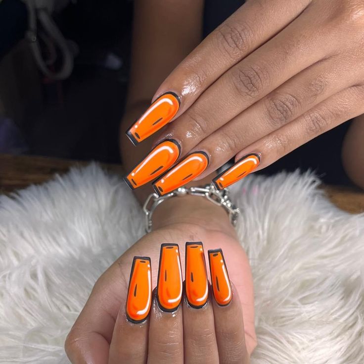 Bold Vibrant Orange Nail Design with Metallic Silver Accents for a Playful Statement Look.