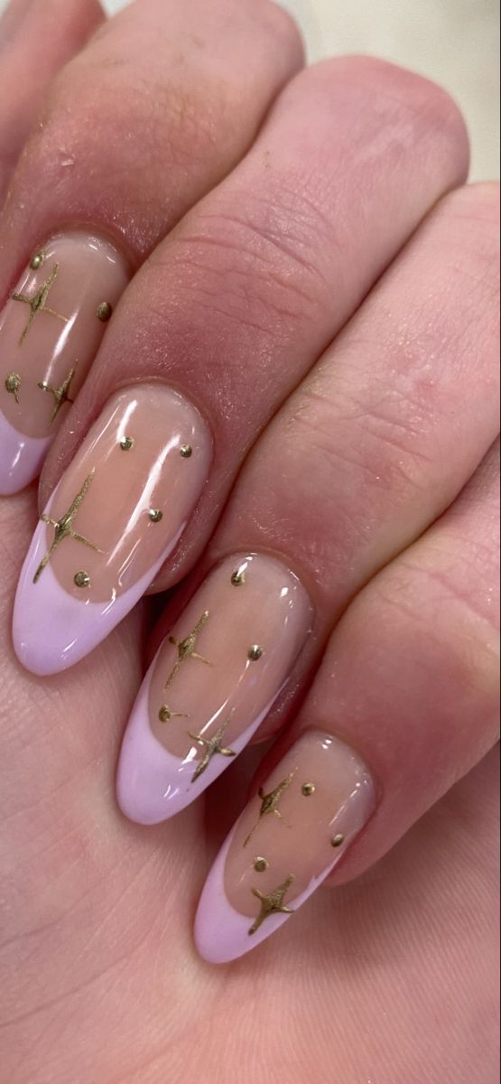 Charming Celestial Nail Design: Soft Pink French Tips with Gold Star Accents on Sheer Nude Base.