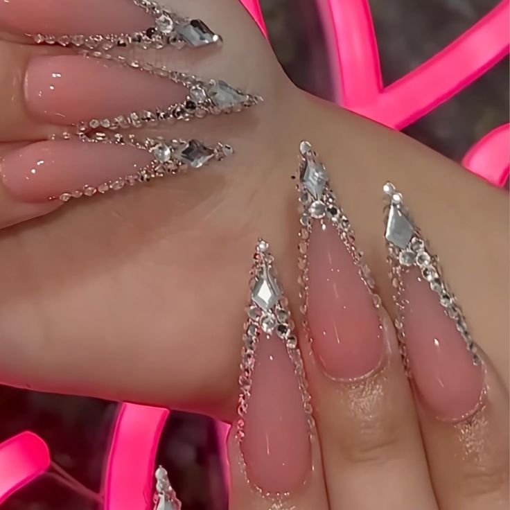 Elegant Stiletto Nail Design with Intricate Details and Dazzling Accents