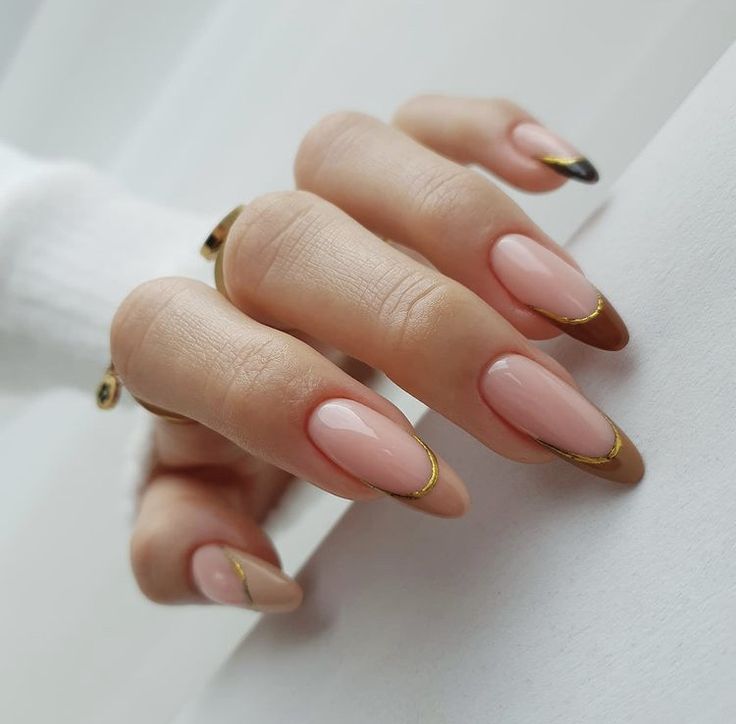 Chic Almond-Shaped Nails: Glossy Nude Base with Elegant Gold Accents