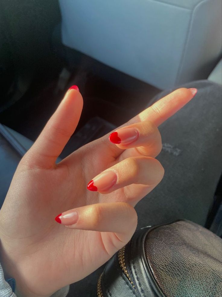 Vibrant Red-Tipped French Manicure: A Chic and Playful Twist on Classic Elegance.