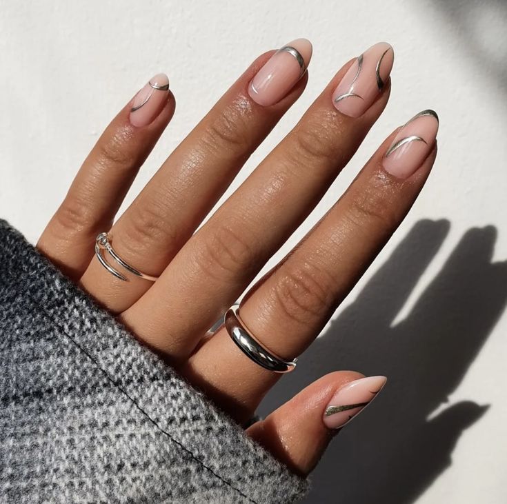 Chic Nude Nail Design with Geometric Lines and Metallic Accents