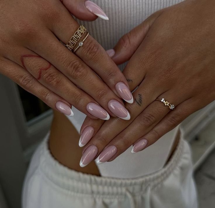 Sophisticated Almond-Shaped Nails: Blush Pink Base and Classic White Tips Enhance Elegance.