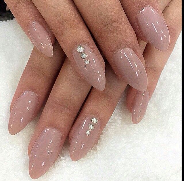 Sophisticated Almond-Shaped Nude Nails with Glamorous Rhinestone Accents.