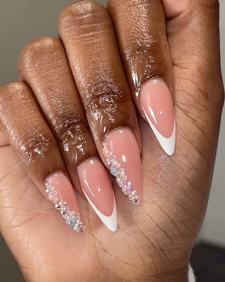 Sophisticated Almond-Shaped Nails: Nude Base with White Tips and Sparkling Rhinestones.