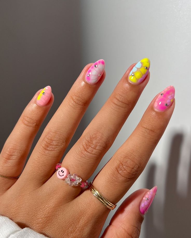 Cheerful Almond-Shaped Nail Design with Whimsical Pink, Yellow, and Blue Patterns