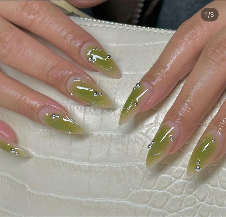 Sophisticated Almond-Shaped Nails with Olive Green Gradient and Metallic Accents.