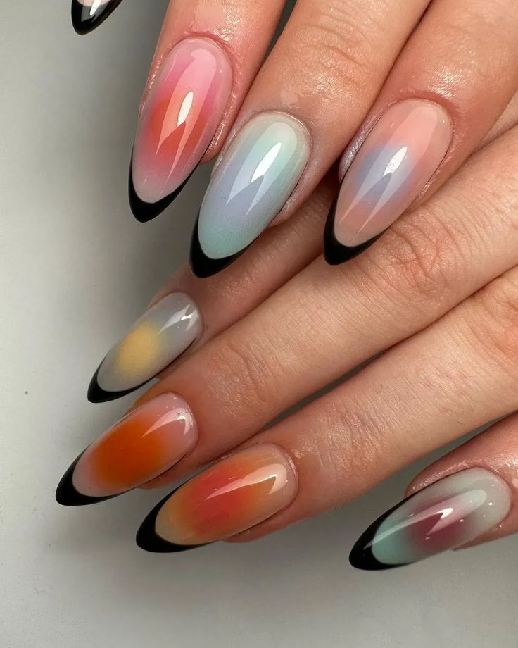 Chic Gradient Nail Design: Soft Pastels with Bold Black Tips for a Modern Look.