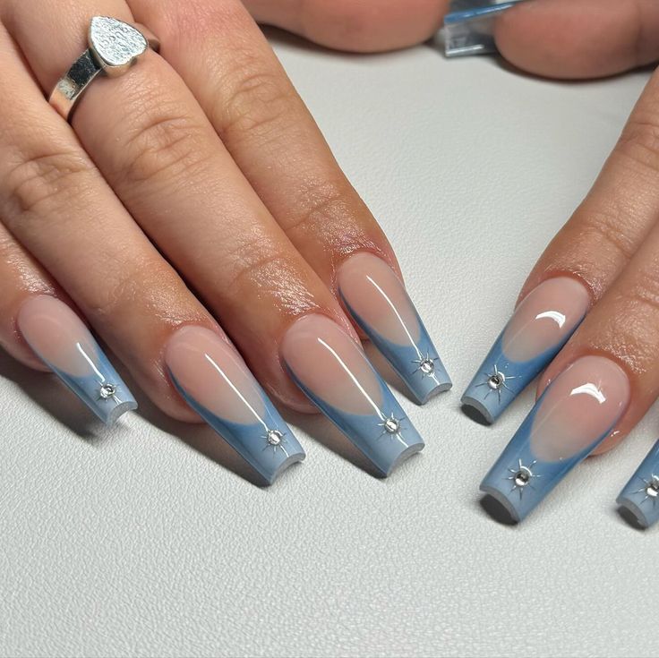 Elegant Nail Design: Soft Beige and Sky Blue with French Tips and Silver Accents.