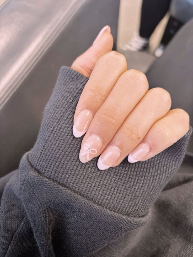 Chic French Tip Nail Design with Elegant Bow on Nude Base